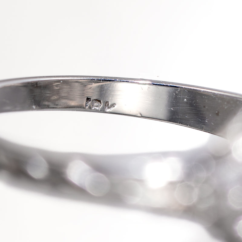 Macro detail of authentic vintage 14K gold hallmark stamp inside ring shank.