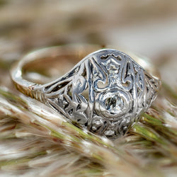 Antique Edwardian silver-topped 14K yellow gold openwork ring set with rose-cut diamonds displayed outdoors