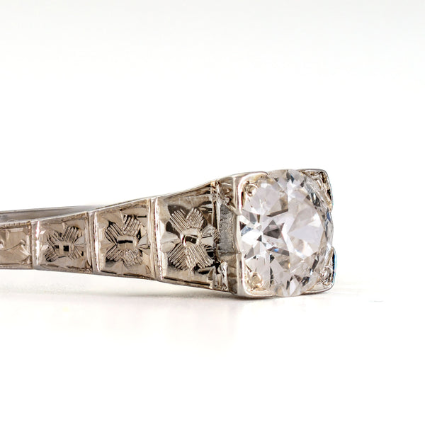Close-up of the hand-engraved floral shoulder detail on an antique Art Deco Cummins-Kremer (CKO) Old European Cut diamond ring.