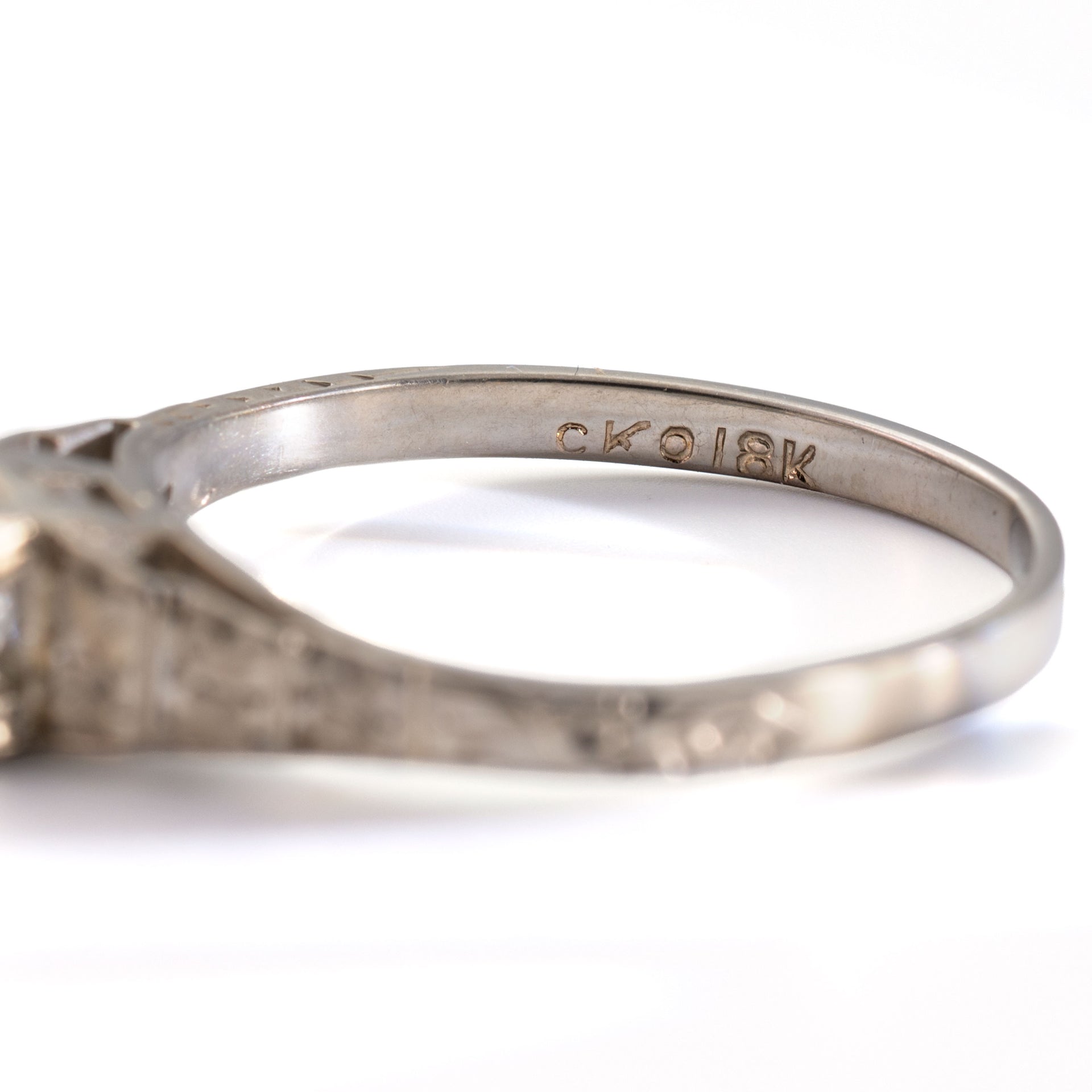 Close-up of the CKO and 18K hallmarks inside an antique Art Deco Cummins-Kremer (CKO) Old European Cut diamond ring in 18K white gold.