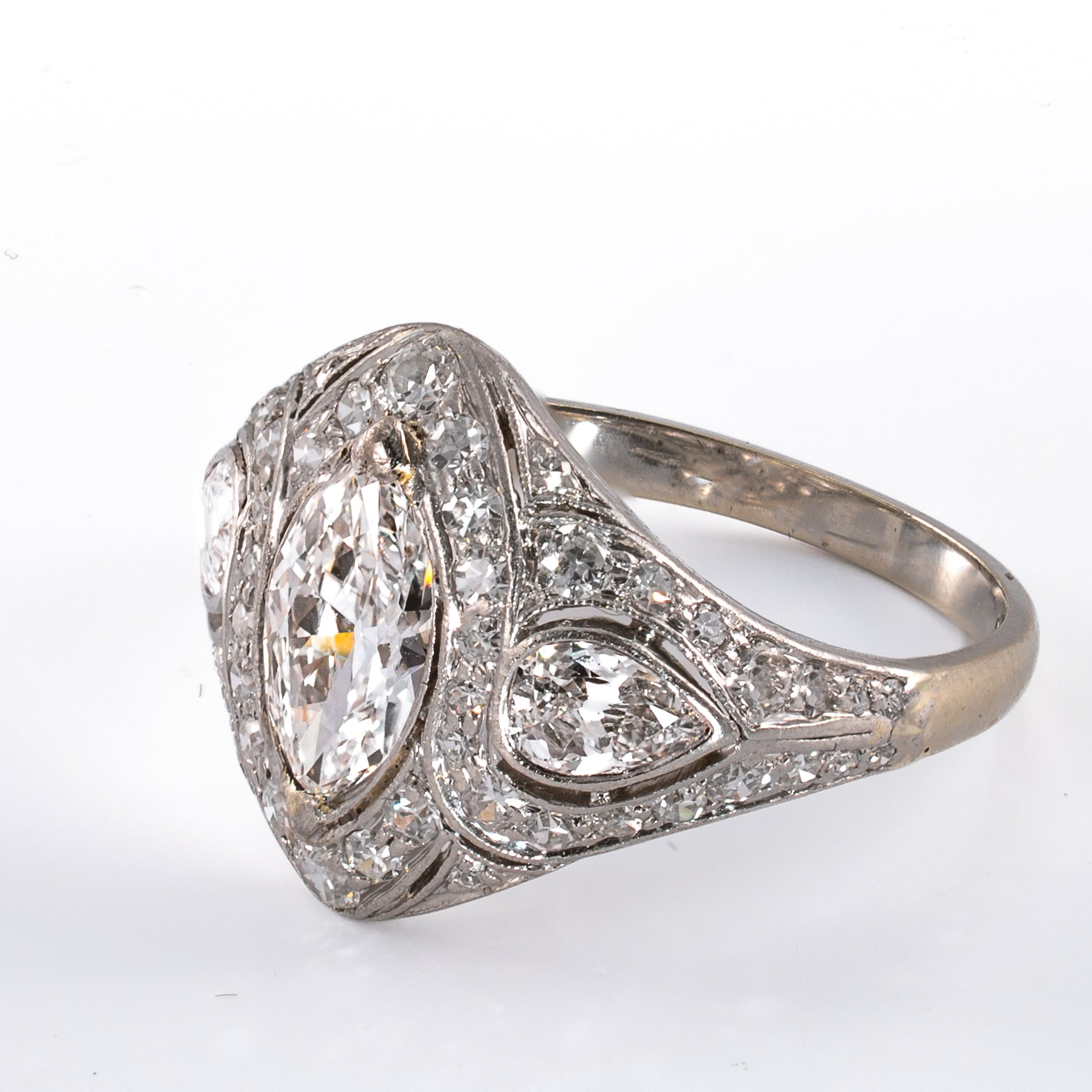 Left side profile view showing hand-cut pear side diamond and milgrain channels