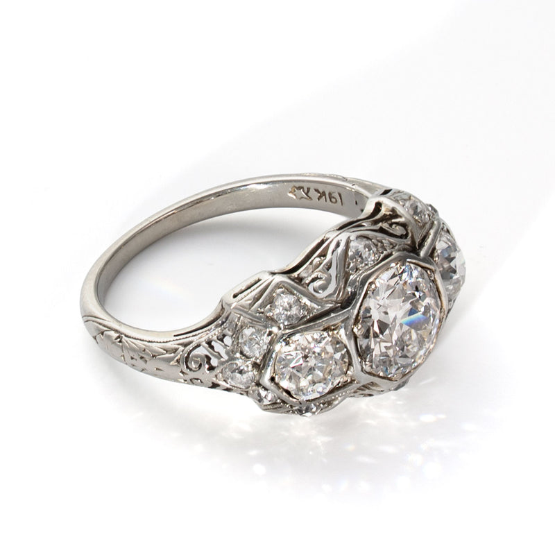 Left profile of an antique Art Deco ring featuring engraved details and Old European Cut diamonds