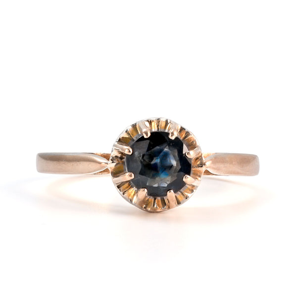 Front view of an antique French 18k yellow gold ring featuring a natural blue sapphire in an eight-prong crown setting.
