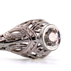 Detailed macro photograph of the bezel-set antique diamond with beautifully engraved shoulders and intricate openwork.