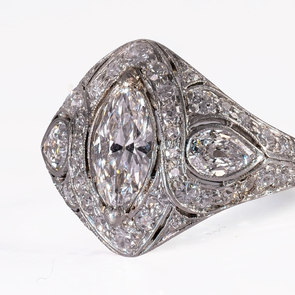 Macro view of hand-cut antique pear diamond with open culet set in bezel frame