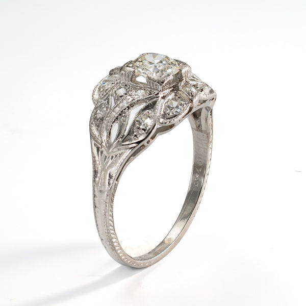 Angled view of antique platinum ring with a .5ct olde european cut diamonds and 16 accent diamonds 
