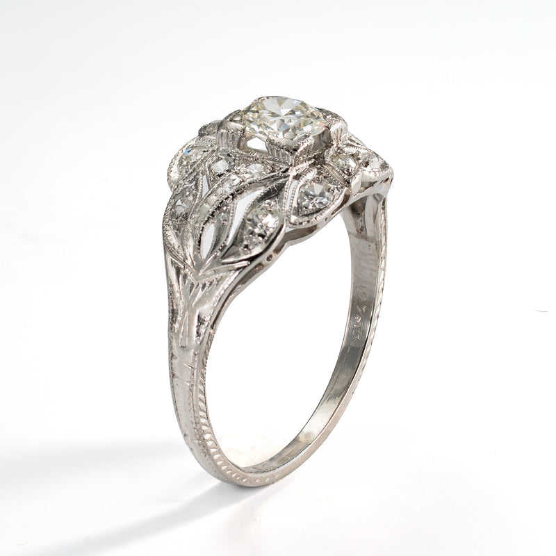 Angled view of antique platinum ring with a .5ct olde european cut diamonds and 16 accent diamonds 