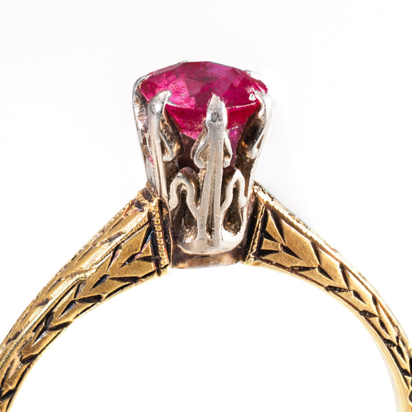 Detailed view of the craftsmanship and engraved shoulders of a late Victorian ruby ring