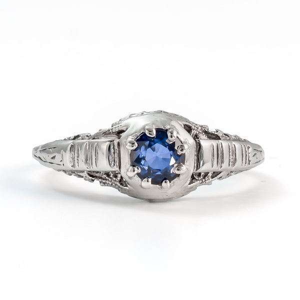 Front view of antique sapphire ring featuring natural blue sapphire and delicate filigree