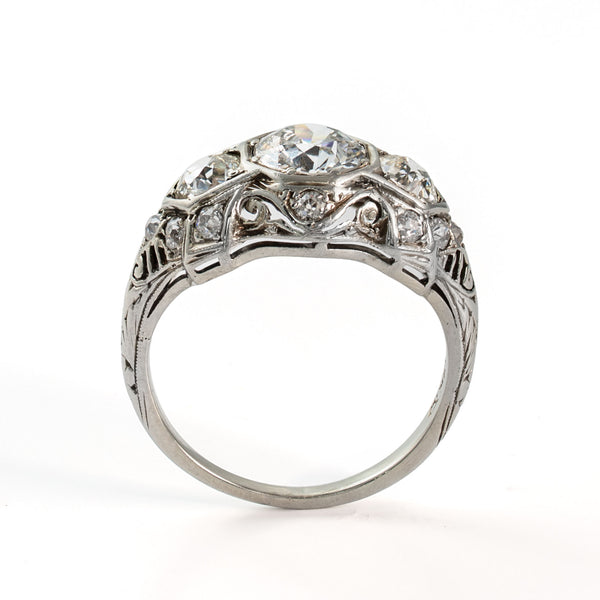 Upright view of an antique three stone diamond ring with layered geometry and strong visual presence