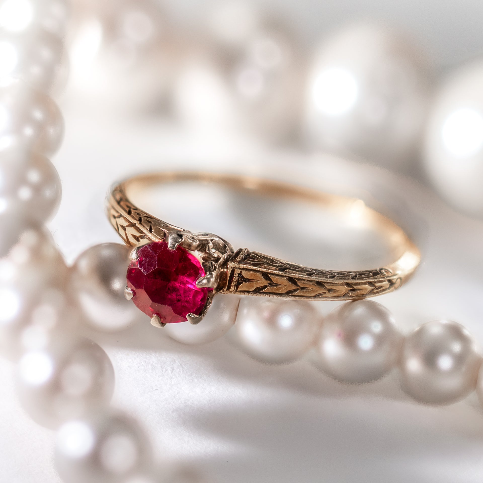 Antique Victorian ruby ring featuring a natural crimson ruby in a hand-engraved 14K yellow gold setting