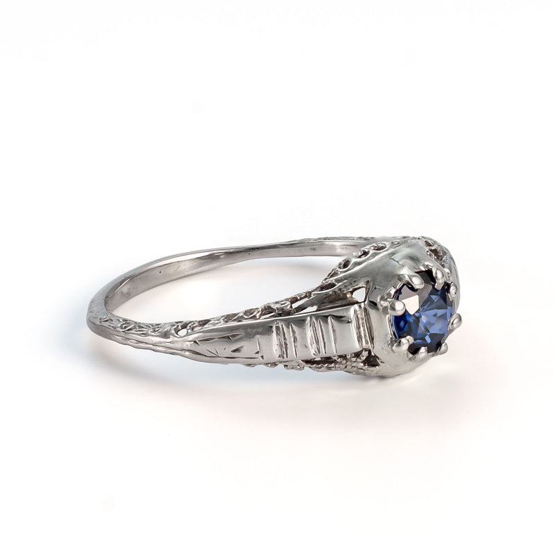 Side profile of antique 14K white gold sapphire ring showing pierced gallery and filigree work