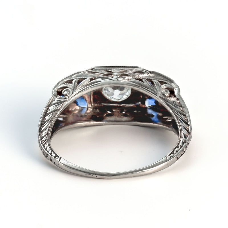 Rear view of an 18k white gold Art Deco shield ring highlighting the openwork gallery and light-portals for diamond brilliance.
