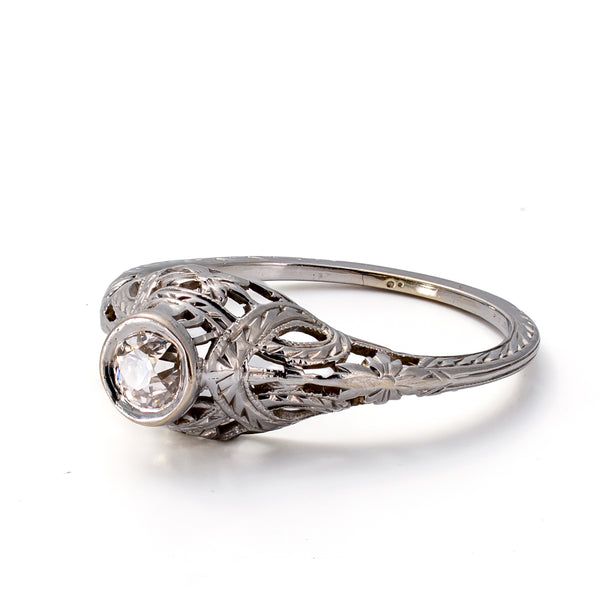 Right side profile showcasing the pierced gallery, hand engraving, and classic bezel-set diamond mounting.