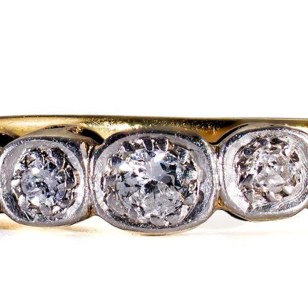 Macro close-up view of hand-cut Old European Cut diamonds set in platinum illusion box settings on an Edwardian 18ct gold ring.