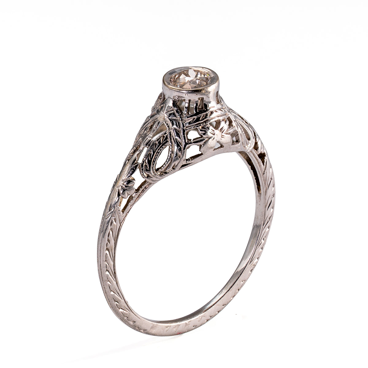 Upright profile displaying the sculpted gallery, floral shoulder decoration, and hand-finished engraving characteristic of transitional jewelry.