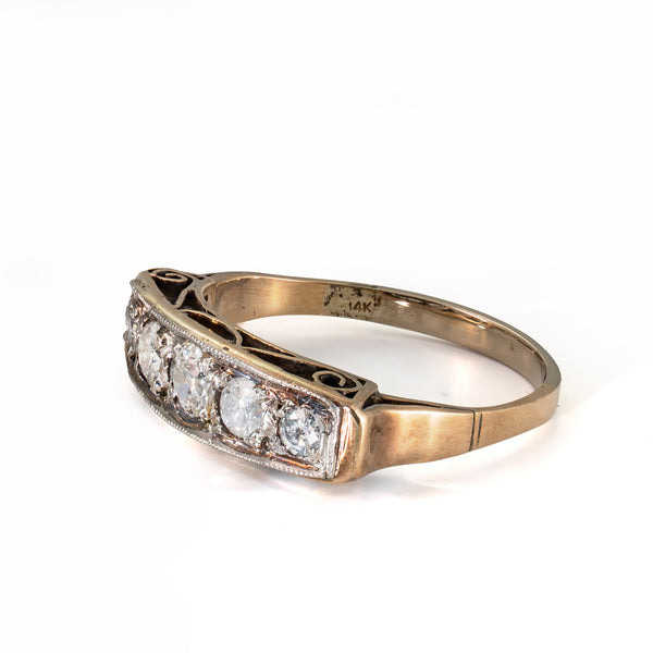 Left profile of a late Edwardian to early Art Deco diamond ring highlighting the pierced gallery and handcrafted design