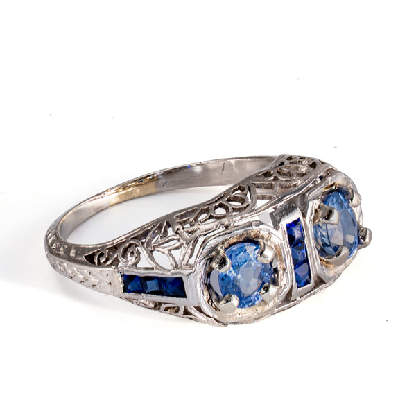 Left profile showing the delicate pierced gallery and hand-finished filigree of an antique sapphire ring.