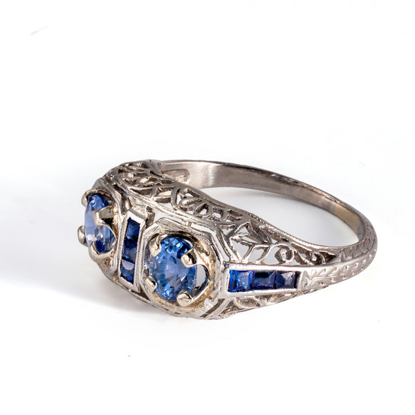 Side profile of an antique filigree sapphire ring displaying graceful Edwardian craftsmanship.