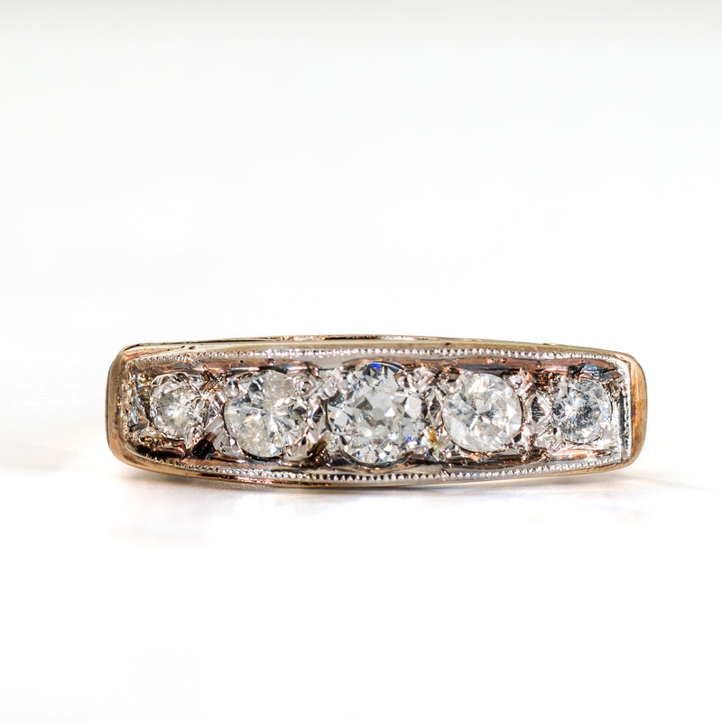 Straight-on view of an antique five-stone diamond ring with Old European Cut center stone and natural old-cut diamonds