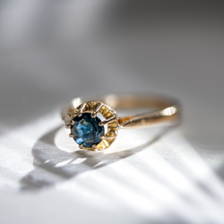 Vintage French sapphire ring in 18K gold photographed in soft natural light