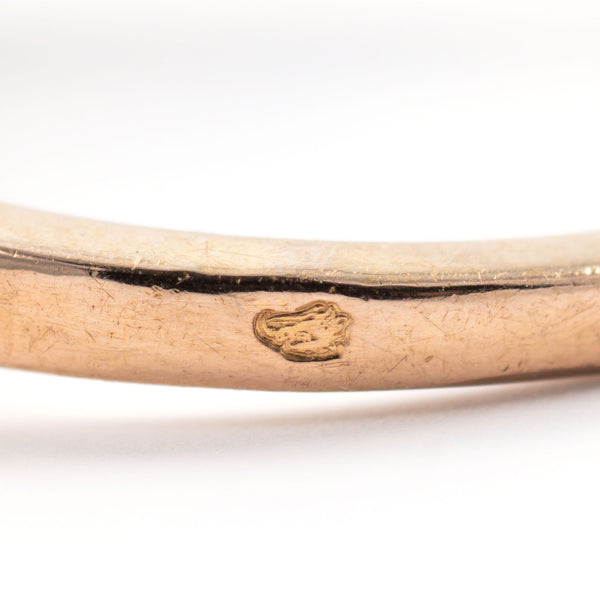 Macro photograph of the official French Eagle's Head hallmark on the exterior shank, certifying 18k gold purity.