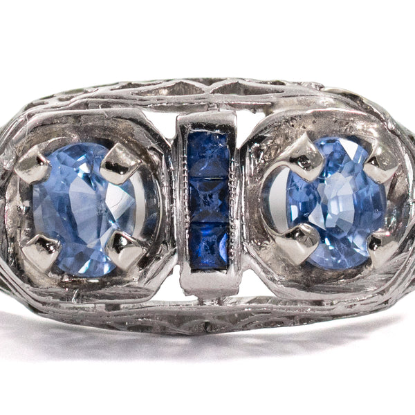 Close-up of two GIL certified natural no-heat blue sapphires accented by calibre-cut sapphires.