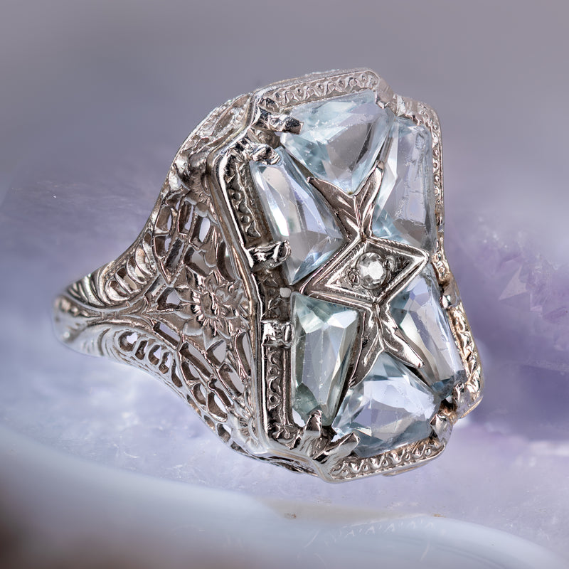 Geometric Art Deco Ring (circa 1920) featuring 6 aquamarines and one center OEC Diamond
