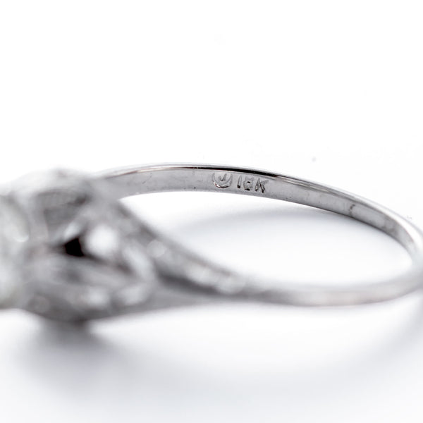 Close-up of a silver ring with '14K' marking on a white background