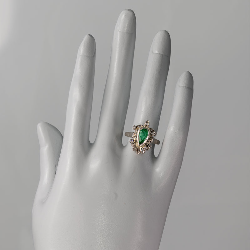 Vintage 1940s palladium pear emerald and diamond foliate ring shown on hand for scale