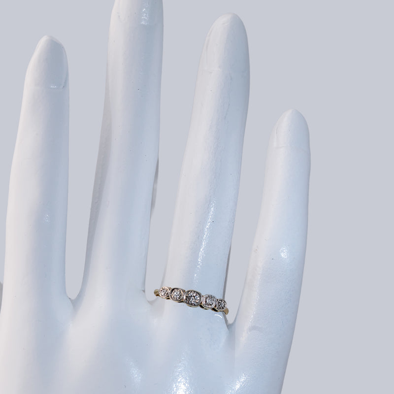 Hand shot of an Edwardian diamond band featuring 5 old European cut diamonds