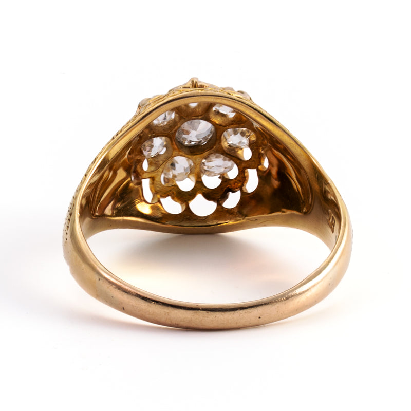 Close-up of the beautifully hand-pierced gallery beneath a Victorian Old Mine Cut diamond cluster ring in solid 18K yellow gold.