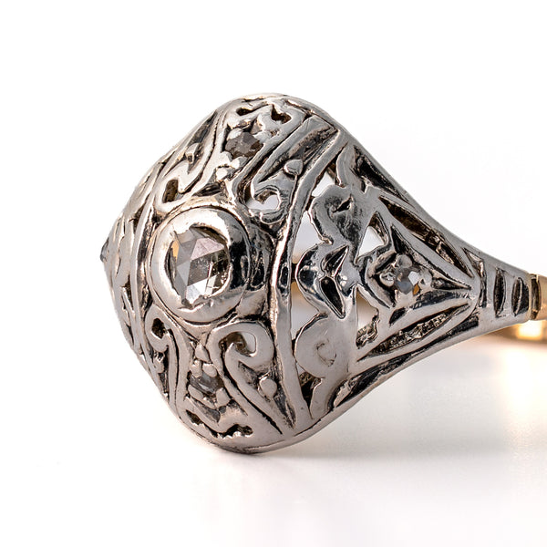 Detailed macro shot of pierced Edwardian silver scrollwork, milgrain wear, and bead-set accent rose-cut diamonds