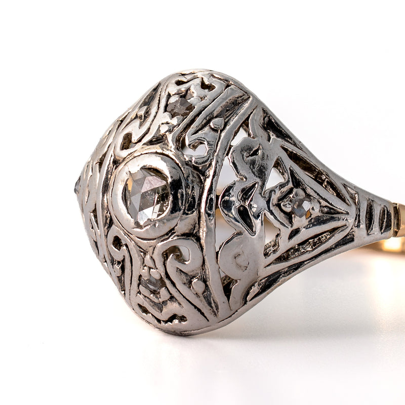Detailed macro shot of pierced Edwardian silver scrollwork, milgrain wear, and bead-set accent rose-cut diamonds