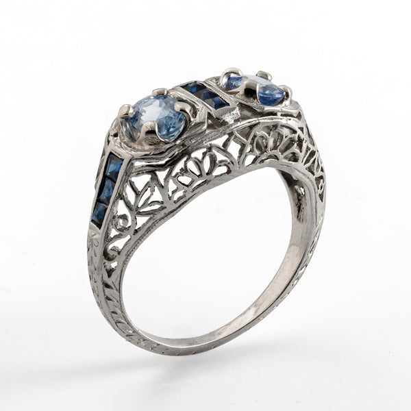 Angled upright photograph revealing the open gallery and intricate filigree of an Edwardian sapphire ring.