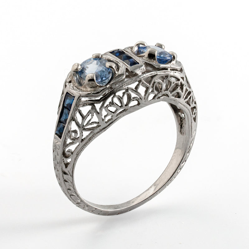 Angled upright photograph revealing the open gallery and intricate filigree of an Edwardian sapphire ring.