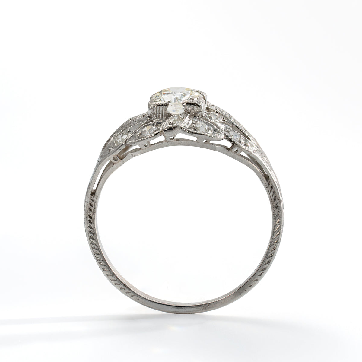 Upright view of antique platinum diamond ring showing Old European Cut center diamond and accent stones