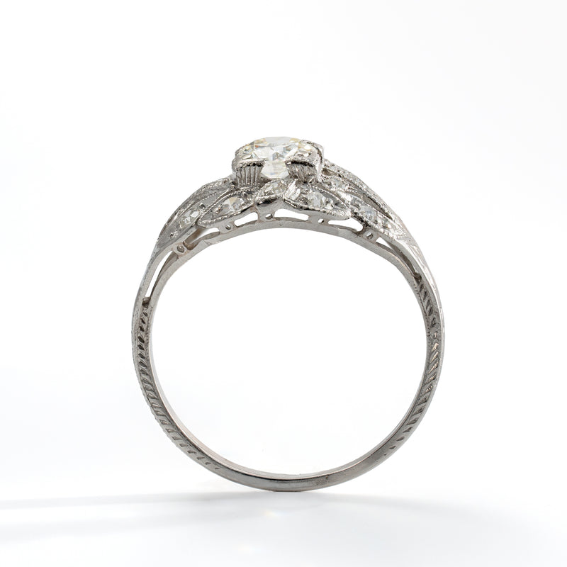 Upright view of antique platinum diamond ring showing Old European Cut center diamond and accent stones
