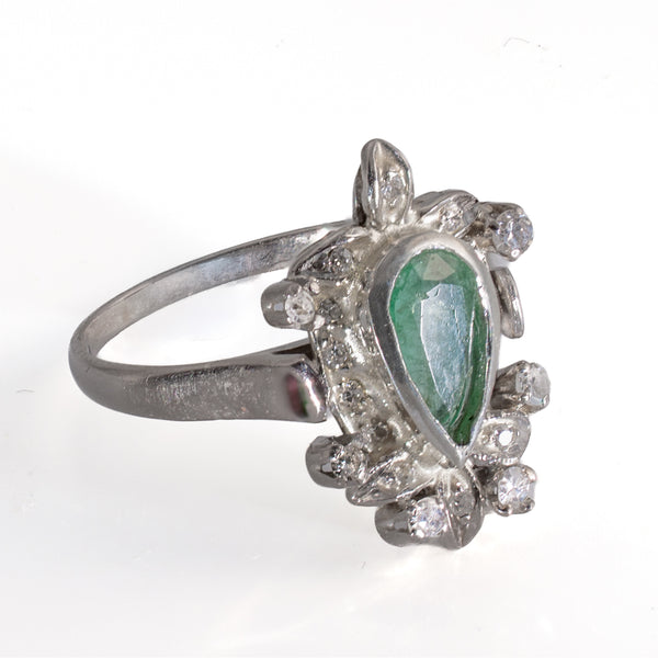 Left side profile view of vintage 1940s palladium foliate cocktail ring with pear emerald and diamond accents