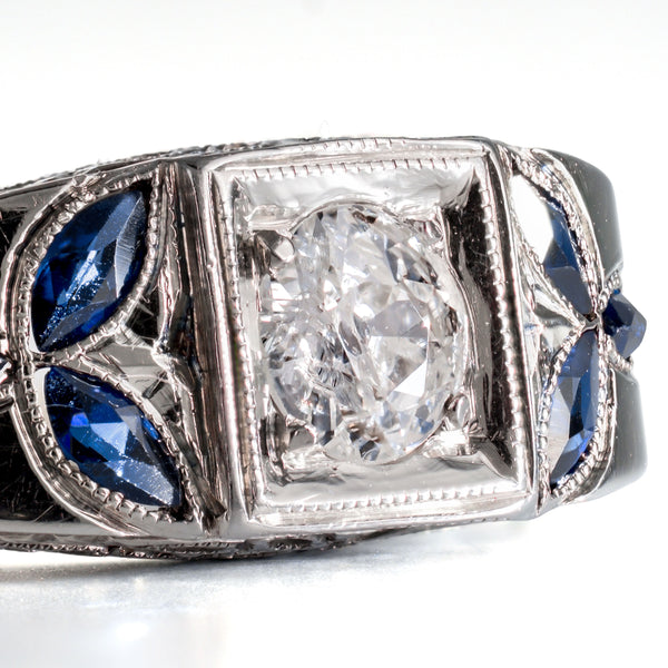 Detail shot of marquise-cut blue sapphires set in an 18k white gold foliate pattern.