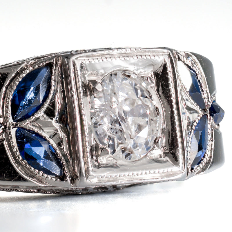 Detail shot of marquise-cut blue sapphires set in an 18k white gold foliate pattern.