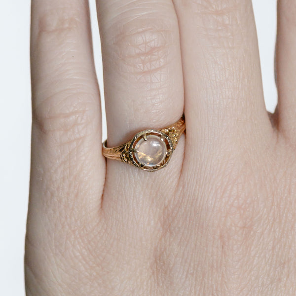 Macro hand view showing the natural moonstone and refined vintage craftsmanship