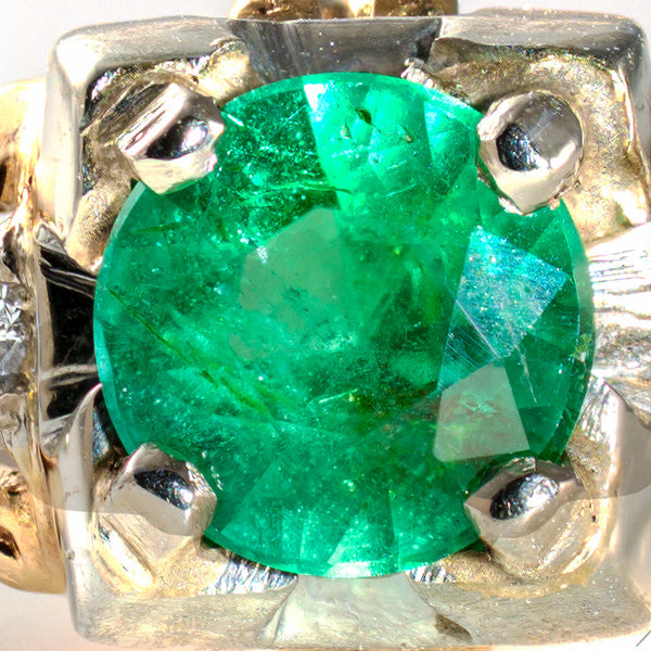 Magnified view of the natural emerald revealing its rich medium-green color and characteristic internal features.