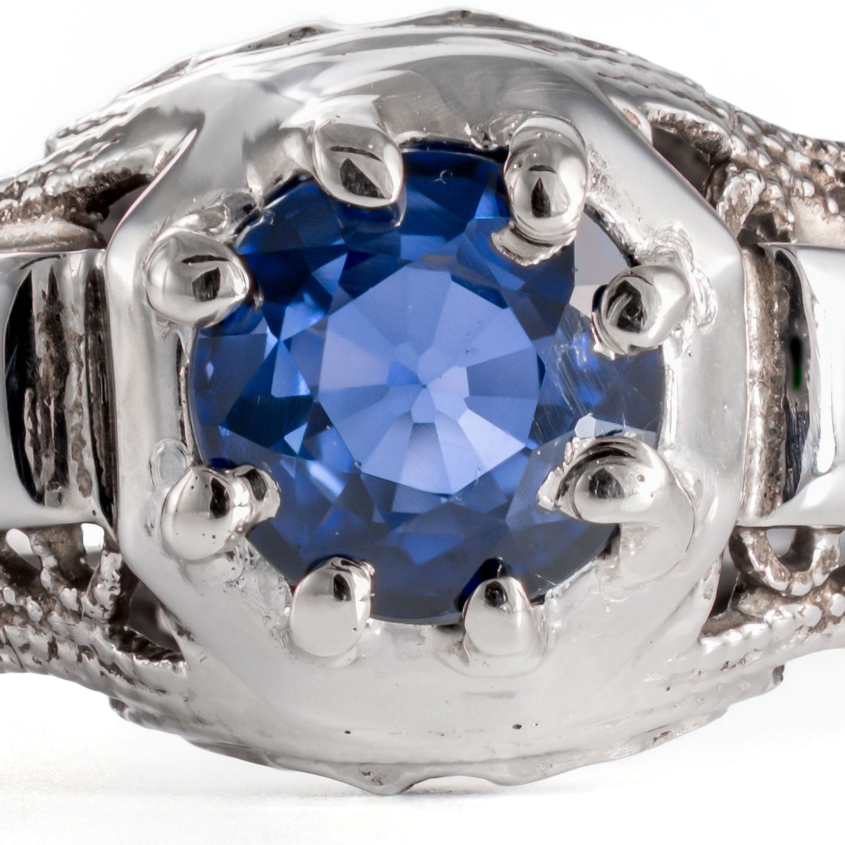 Macro image of natural blue sapphire showing facet detail and rich royal blue color