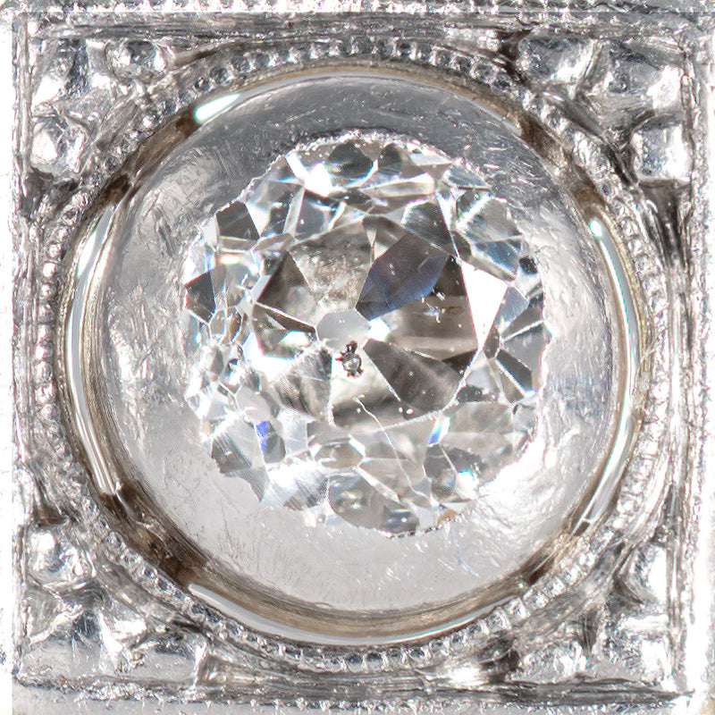 Close up photograph of an Old European cut diamond in an Art Deco shield form ring