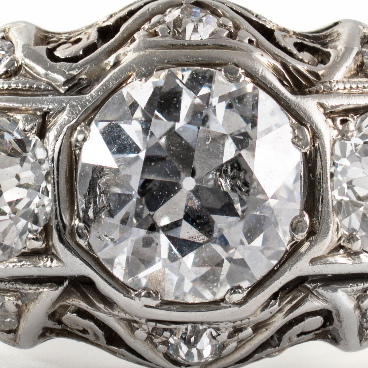 Close-up of antique Old European Cut diamonds displaying high crowns, open culets, and period faceting