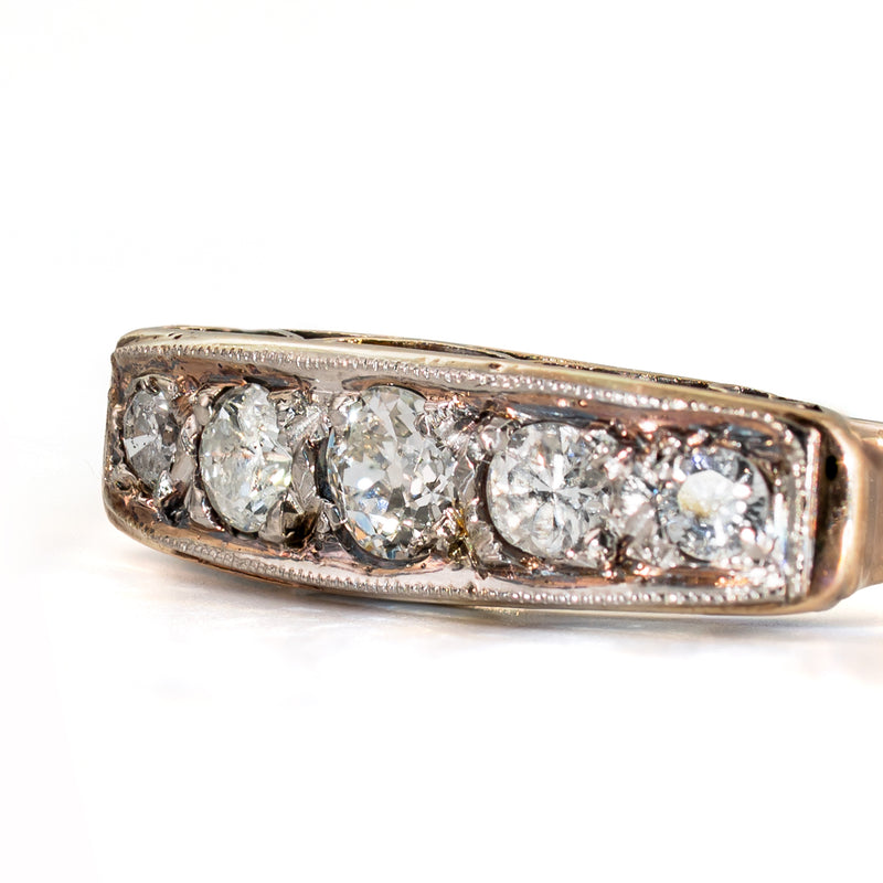 Angled view of an antique five-stone ring featuring an Old European Cut center diamond and four old-cut side diamonds