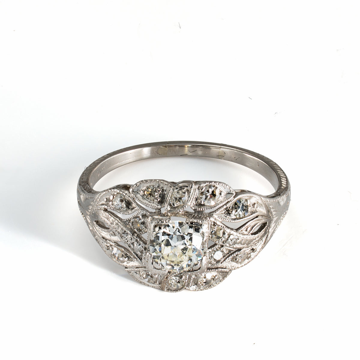Elevated front view of antique platinum diamond ring with softly raised diamond-set design