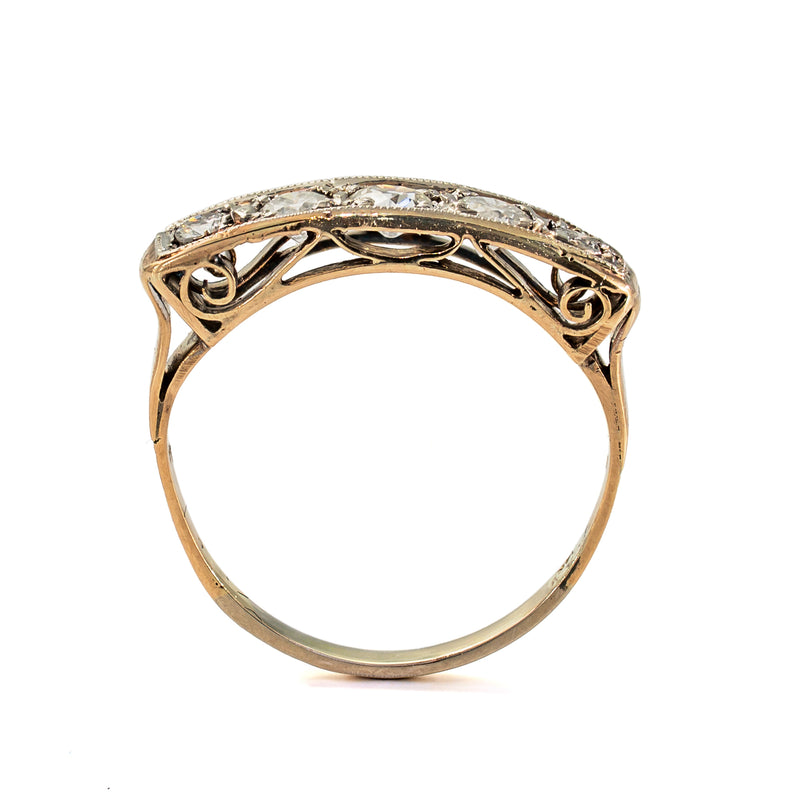 Upright profile highlighting the elegant pierced gallery beneath an antique five-stone diamond ring