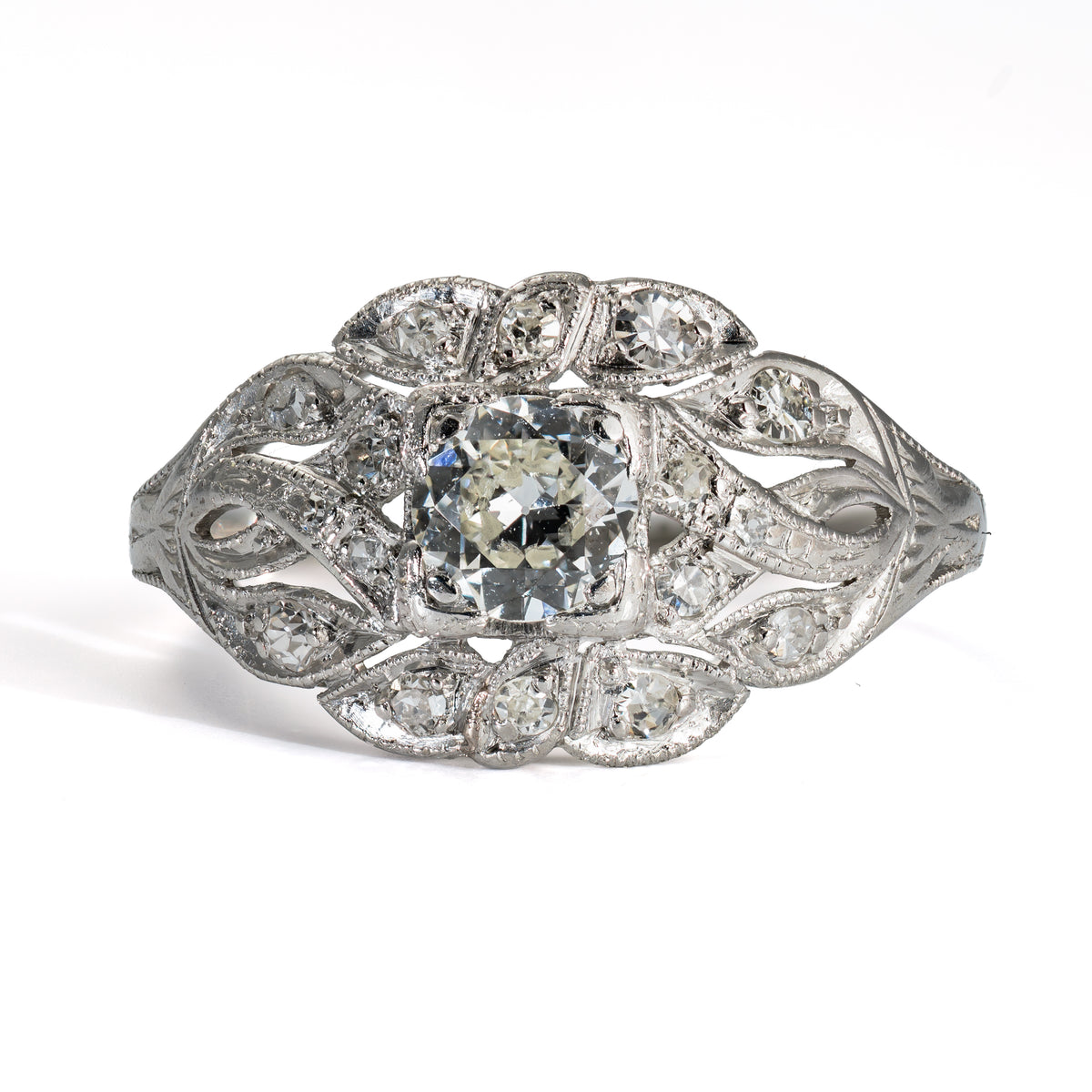 Front view of antique platinum diamond ring with 17 diamonds and hand-pierced openwork design